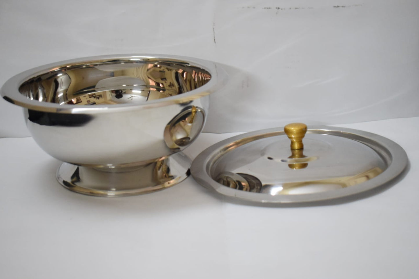Salan Saver stainless steel serving bowl with lid beside bowl